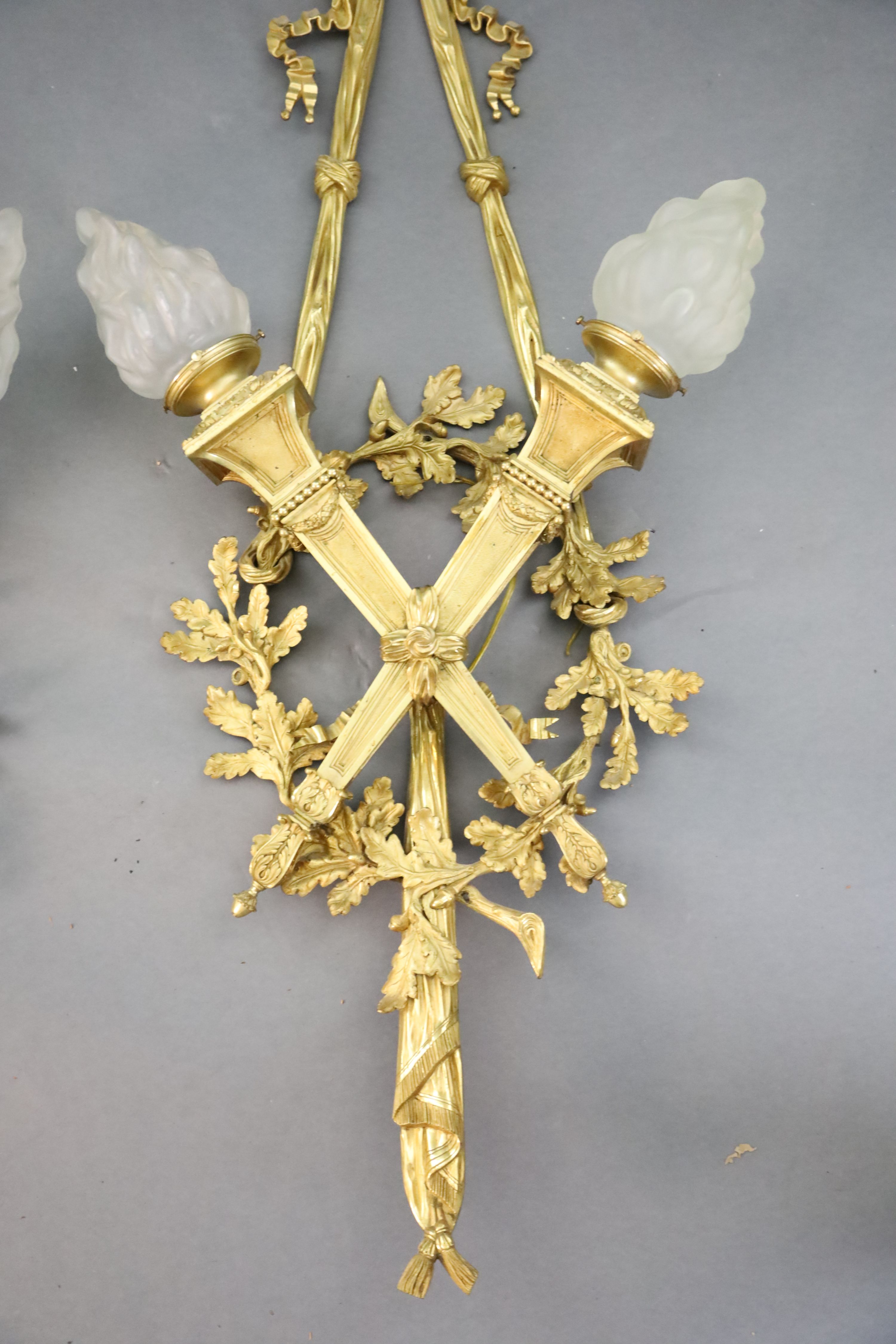 A pair of early 20th century Louis XVI style ormolu wall lights, width 1ft 10in. height 4ft 2in.